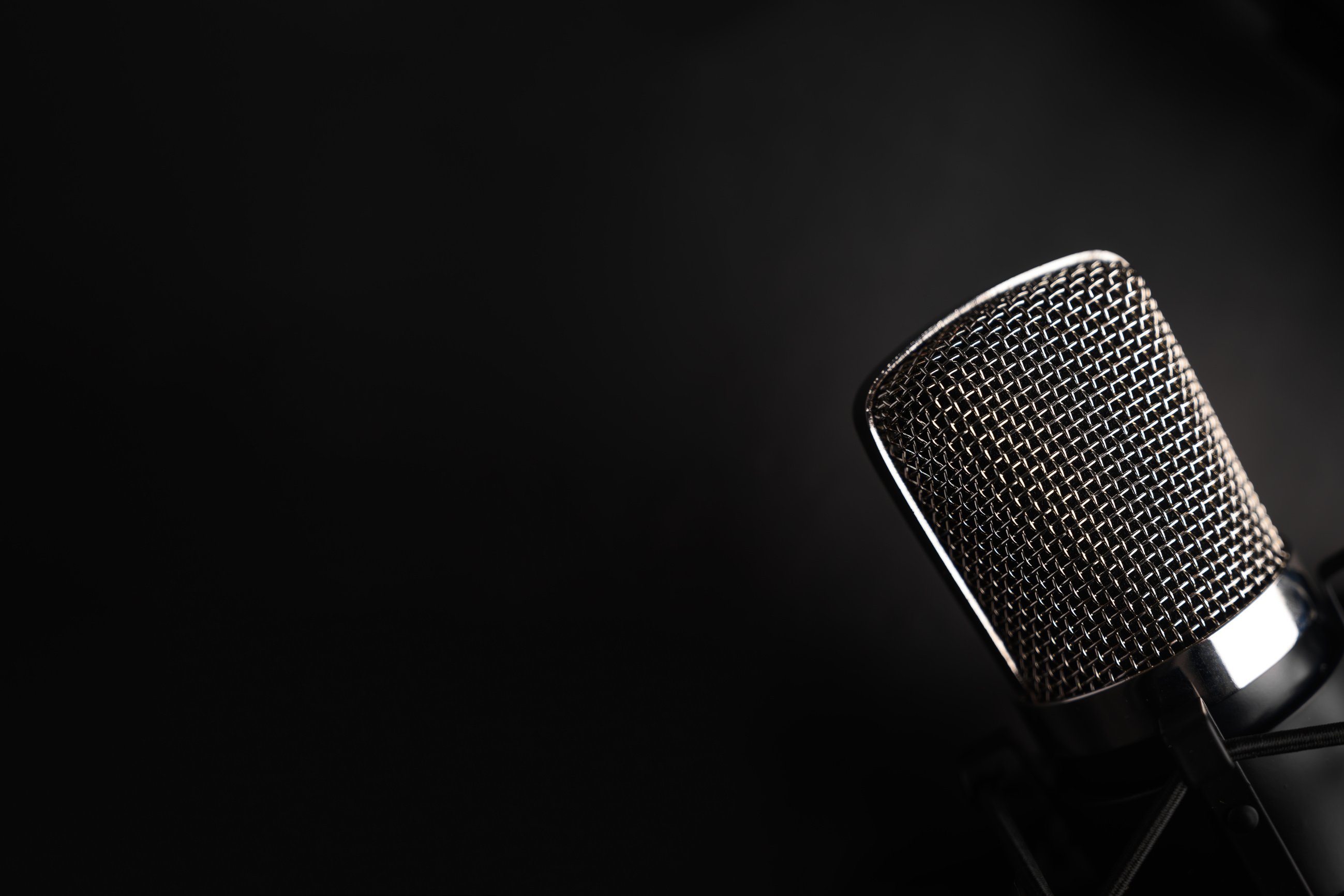 Condenser black studio microphone on a black background. Streamer, podcasts, music background